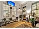 Cozy front porch featuring a wooden bench, stylish decor, and views of the dining room beyond the front door at 1525 Harriman St, Mount Pleasant, SC 29466