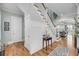 Bright hallway with hardwood floors, elegant staircase, and a view of the living room at 1525 Harriman St, Mount Pleasant, SC 29466