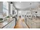 Spacious kitchen featuring granite countertops, stainless steel appliances, and white cabinetry overlooking dining and living areas at 1525 Harriman St, Mount Pleasant, SC 29466