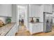 Well-appointed kitchen featuring granite countertops, white cabinetry, stainless steel appliances, and seamless flow into the dining area at 1525 Harriman St, Mount Pleasant, SC 29466