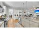 Open-concept kitchen with a large island, granite countertops, stainless steel appliances, and views into the living and dining areas at 1525 Harriman St, Mount Pleasant, SC 29466
