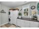 Functional laundry room with stacked washer/dryer, ample cabinetry, and a window at 1525 Harriman St, Mount Pleasant, SC 29466