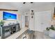 This living room features a mounted flatscreen TV and an adjacent staircase and closet at 1525 Harriman St, Mount Pleasant, SC 29466