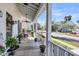 Inviting porch with ceiling fan, chairs, and lush landscaping for outdoor relaxation at 1525 Harriman St, Mount Pleasant, SC 29466