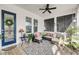 Comfortable covered porch with plush seating, stylish rug, and a ceiling fan for warm days at 1525 Harriman St, Mount Pleasant, SC 29466