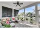 Relaxing screened porch with comfortable seating, ceiling fan, and views of the neighborhood at 1525 Harriman St, Mount Pleasant, SC 29466