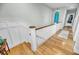 Elegant stairway with wooden treads, white wainscoting, and surfboard decor in the hallway at 1525 Harriman St, Mount Pleasant, SC 29466