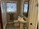 Compact bathroom with a pedestal sink, toilet, and shower curtain at 161 Gordon Street, Charleston, SC 29403