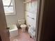 Dated pink bathroom featuring a bathtub, toilet, sink, and old-fashioned tile at 161 Gordon Street, Charleston, SC 29403