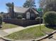A classic brick house featuring a metal roof, complemented by well-maintained landscaping and a brick perimeter at 161 Gordon Street, Charleston, SC 29403