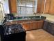 Cozy kitchen with wood cabinets, laminate countertops, and a stainless steel sink at 161 Gordon Street, Charleston, SC 29403