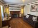 Living room with hardwood floors, fireplace, brown sofa, and vintage decor at 161 Gordon Street, Charleston, SC 29403