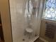 Shower with tiled walls, clear curtain, and seat in an updated bathroom at 161 Gordon Street, Charleston, SC 29403