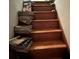 Wooden staircase cluttered with piles of magazines and books at 161 Gordon Street, Charleston, SC 29403