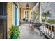 Relaxing front porch with comfortable seating, a stylish rug, and classic architectural details at 171 Broad St, Charleston, SC 29401