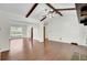 Spacious living room showcasing vaulted ceiling with exposed wood beams, wood floors, and a large window overlooking the front yard at 209 Pointer Dr, Summerville, SC 29485