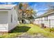 A backyard with an unattached garage, set on a lawn beneath a sunny sky at 2120 Thornlee Dr, North Charleston, SC 29405