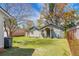 A backyard with an unattached garage, set on a lawn beneath a sunny sky at 2120 Thornlee Dr, North Charleston, SC 29405