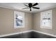 Bedroom with two windows offering natural light and dark floors complementing the neutral walls at 2120 Thornlee Dr, North Charleston, SC 29405