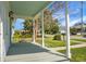 Cozy front porch with calming gray tones, providing a shaded retreat with a view of the quiet neighborhood at 2120 Thornlee Dr, North Charleston, SC 29405