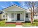Inviting front porch with brick steps, offering a shaded retreat with a view of the landscaped yard at 2120 Thornlee Dr, North Charleston, SC 29405