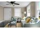 Cozy living room featuring a comfortable couch, ceiling fan, and bright natural light at 2120 Thornlee Dr, North Charleston, SC 29405
