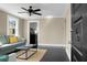 Cozy living room with sleek dark floors, complemented by a modern ceiling fan and comfortable furnishings at 2120 Thornlee Dr, North Charleston, SC 29405