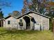 A sunny-day shot of an unattached garage with weathered wood siding at 2120 Thornlee Dr, North Charleston, SC 29405