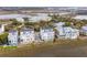 Wide aerial shot of modern townhouses, enhanced by the picturesque blend of greenery and expansive marsh landscape at 2135 Tides End Rd, Charleston, SC 29412