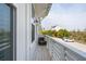 Seating on the balcony offers an outdoor space to relax and enjoy the neighborhood view at 2135 Tides End Rd, Charleston, SC 29412