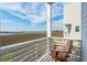Balcony with scenic marsh views and comfortable Adirondack chairs to relax and enjoy the scenery at 2135 Tides End Rd, Charleston, SC 29412