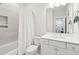 Bright bathroom featuring a shower-tub combo with a white shower curtain and a white vanity with modern hardware at 2135 Tides End Rd, Charleston, SC 29412