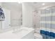 Bright bathroom featuring a shower-tub combo with a striped curtain and a white vanity with chrome hardware at 2135 Tides End Rd, Charleston, SC 29412