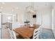 Dining room with an exposed wood table, seating for six, modern chandelier, and an area for a piano at 2135 Tides End Rd, Charleston, SC 29412