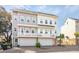 Coastal townhome boasts modern design elements, complemented by a small palm tree for an added touch of tropical charm at 2135 Tides End Rd, Charleston, SC 29412