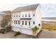 Charming coastal townhome with a private balconies, showcasing its unique architectural design and inviting curb appeal at 2135 Tides End Rd, Charleston, SC 29412