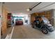 Spacious garage featuring a golf cart, minivan, storage shelves, wood paneling, and an overhead door at 2135 Tides End Rd, Charleston, SC 29412