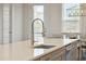 This kitchen island includes a large sink with a pull down faucet and a quartz countertop at 2135 Tides End Rd, Charleston, SC 29412