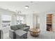 Upstairs living area features a gray sectional, round coffee table, a projector, and a door to the deck at 2135 Tides End Rd, Charleston, SC 29412