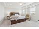 Spacious main bedroom with a large bed, side tables, and tray ceilings at 2135 Tides End Rd, Charleston, SC 29412