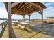 Outdoor area with picnic tables and a wooden pavilion overlooking the marsh and a waterway at 2135 Tides End Rd, Charleston, SC 29412