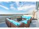 Rooftop patio featuring outdoor seating with brown wicker frames and blue cushions overlooking the marsh at 2135 Tides End Rd, Charleston, SC 29412