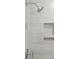 Close up of the tiled shower with storage nook and modern fixtures at 2135 Tides End Rd, Charleston, SC 29412