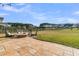 Spacious backyard featuring a stone patio with a fire pit and serene lake views at 219 Daybreak Blvd, Summerville, SC 29486