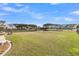 Large grassy backyard with a pond view and a stone patio area at 219 Daybreak Blvd, Summerville, SC 29486