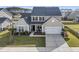 Charming home features a two-car garage, manicured lawn, and a cozy porch with lovely landscaping at 219 Daybreak Blvd, Summerville, SC 29486