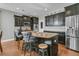 This kitchen boasts dark cabinets, stainless steel appliances, a granite island, and stylish bar stool seating at 219 Daybreak Blvd, Summerville, SC 29486