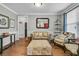 Cozy living room with hardwood floors, a comfortable beige sofa, and stylish decor, creating an inviting atmosphere at 219 Daybreak Blvd, Summerville, SC 29486