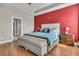 Bright and airy main bedroom with a red accent wall, and hardwood floors at 219 Daybreak Blvd, Summerville, SC 29486