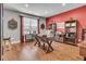 Bright office space with hardwood floors, a decorative red accent wall, and ample natural light at 219 Daybreak Blvd, Summerville, SC 29486